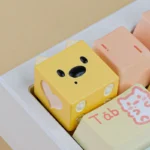A whimsical candy-colored resin puppy ESC keycap, meticulously handcrafted, showcasing its unique playful design and vibrant hues from a charming design.