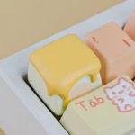 Whimsical candy puppy honey marshmallow keycap. Handcrafted resin ESC art, unique and vibrant. Shown from a playful angle, highlighting meticulous details.