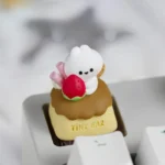 Close-up of a handcrafted whimsical caramel pudding rabbit artisan keycap, showcasing the adorable bunny nestled in golden dessert with playful detail.
