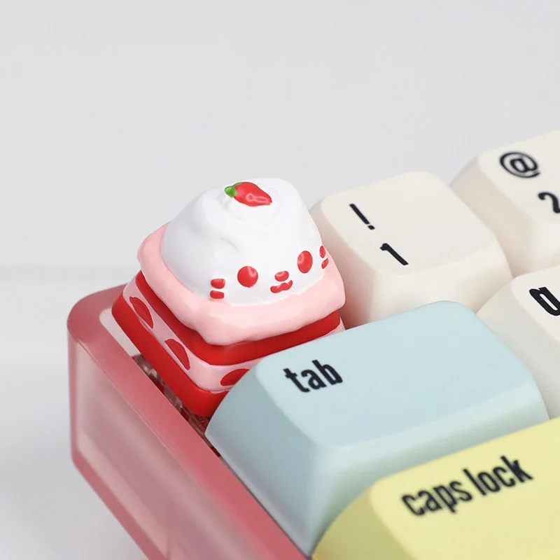 Close-up views of the adorable handcrafted resin Cat Cake Keycap, showcasing its whimsical cat and vibrant dessert details from various angles. A joyful design.