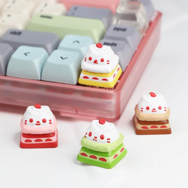 Showcases an exquisitely handcrafted resin cat cake keycap, featuring a whimsical cat atop a vibrant, adorable dessert. A playful keyboard accent.
