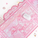 Playful angle of the Whimsical Cat Claw Machine Desk Mat. Vibrant cat and arcade illustrations offer charming arcade fun.