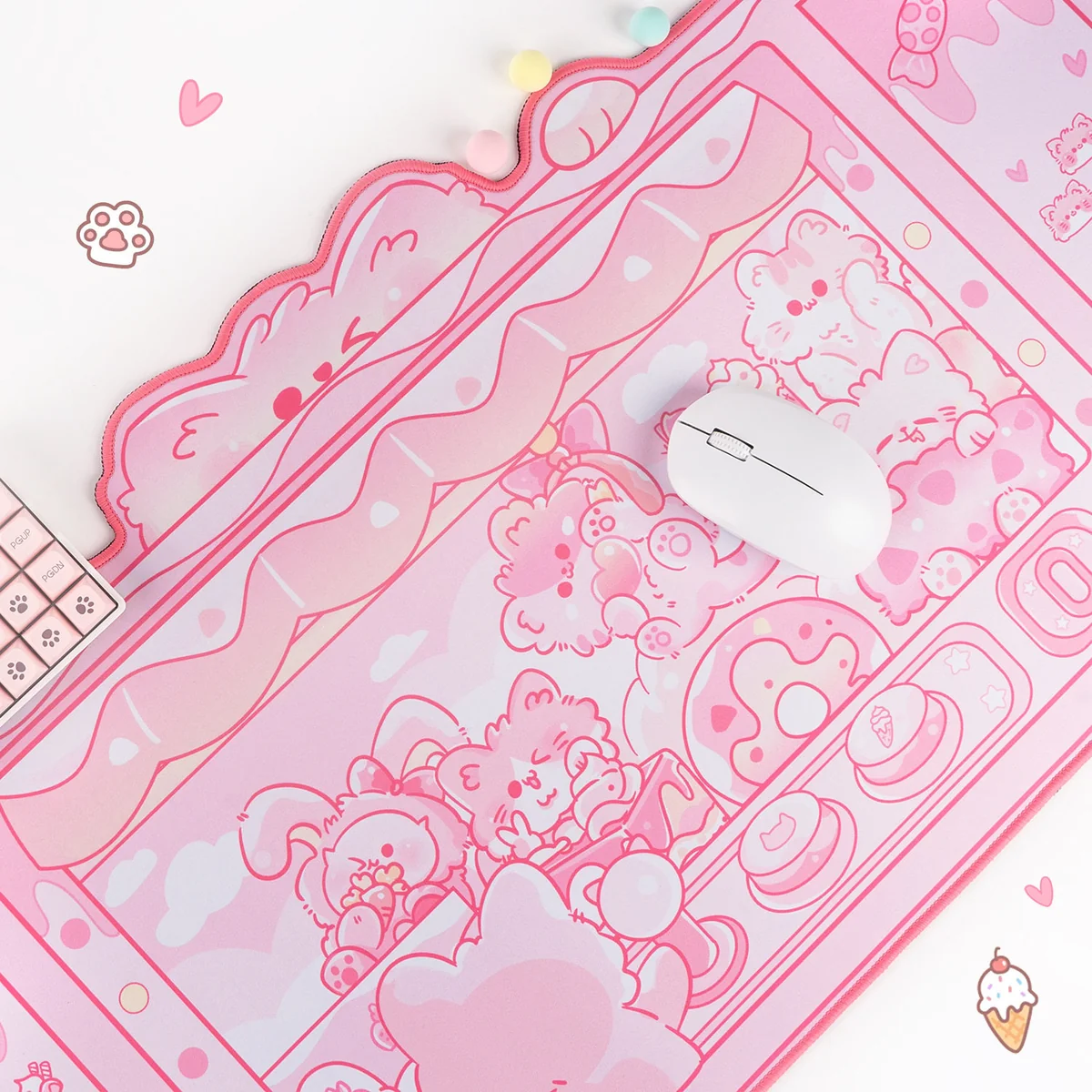 Playful angle of the Whimsical Cat Claw Machine Desk Mat. Vibrant cat and arcade illustrations offer charming arcade fun.
