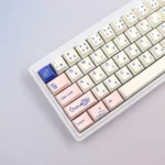 Close-up of adorable PBT cat keycaps set, showcasing whimsical Japanese feline designs with soft hues dye-sublimated details from a playful design.