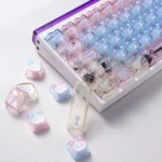 Close-up of whimsical translucent PC cat keycaps set, showcasing adorable lazy cat designs and playful bonus paw keycaps from a side angle.