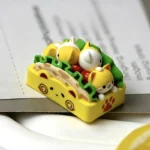 Close-up of a whimsical handcrafted resin cat Taco keycap, showcasing its unique design and vibrant artisan details from a different angle.