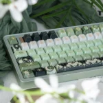 Artistic Celestial Keycap, pearlescent night sky artisan. Unique angle shows deep green cosmic hues, shimmering celestial motifs, intricate craftsman.