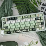 An enchanting Celestial keycap, showcasing a shimmering pearlescent night sky artisan design with deep green cosmic hues and subtle celestial motifs.