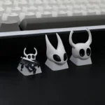Handcrafted Artisan Hollow Knight Hornet resin keycap, meticulously detailed, showcased from various angles to highlight its intricate dark fantasy.