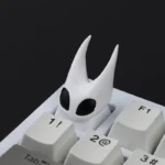 Handcrafted Hollow Knight Hornet resin keycap, an intricate artisan piece with dark fantasy details. Perfect game-accurate collectible.