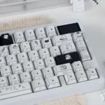 Whimsical Chiikawa Joke Bear PBT keycap set from a dynamic angle, highlighting side-engraved legends.