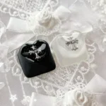 Angled Chrome Hearts Keycap, highlighting its iconic gothic cross and heart design. Its foggy transparency gives it a premium, edgy, monochromatic design.