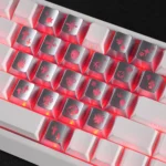A detailed view of the iconic Chrome Hearts Supplement Keycap Set, showcasing the sleek gothic heart motif and translucent PC material from a striking angle.