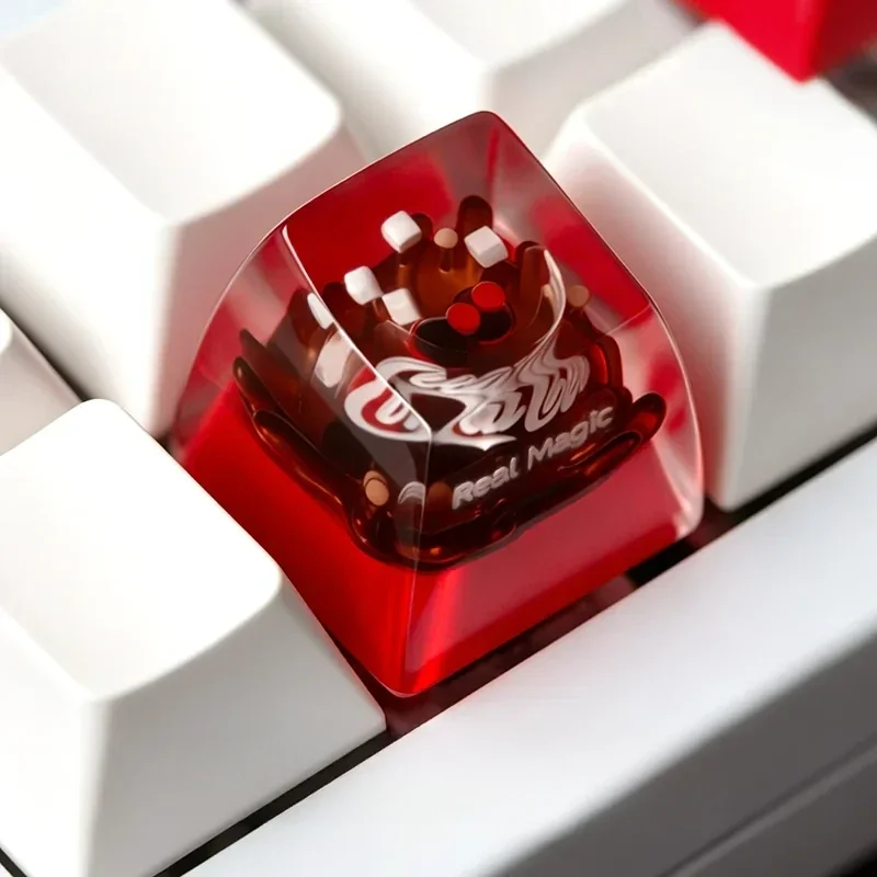 Iconic Coca-Cola artisan ESC keycap crafted from glossy resin. Multiple angles showcase its classic white branding and vibrant retro design.