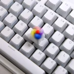 Vibrant handcrafted spinning windmill keycap from an artistic angle, showcasing its colorful rotating blades and miniature design with whimsical charm.
