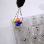A close-up view of the handcrafted rotating colorful spinning windmill keycap, showcasing its vibrant miniature design and intricate blades from a unique design.