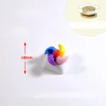 Handcrafted rotating colorful spinning windmill keycap, seen from a new angle, accentuating its vibrant miniature design and dynamic blades.