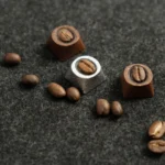 Detailed view of an artisan coffee bean keycap, showing real coffee beans encased in clear handcrafted resin with warm, natural aesthetics.