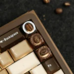 Artisan Coffee Bean Keycap, a handcrafted resin charm featuring real coffee beans. Clear resin showcases warm, natural aesthetics.