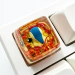 Vibrant, handcrafted Cyndaquil Pokémon artisan keycap, expertly sculpted from resin with translucent details, ideal for keyboard enthusiasts.
