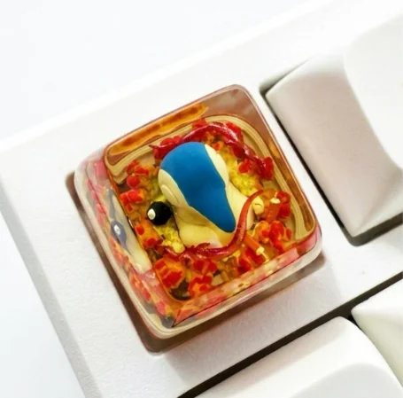 Vibrant, handcrafted Cyndaquil Pokémon artisan keycap, expertly sculpted from resin with translucent details, ideal for keyboard enthusiasts.