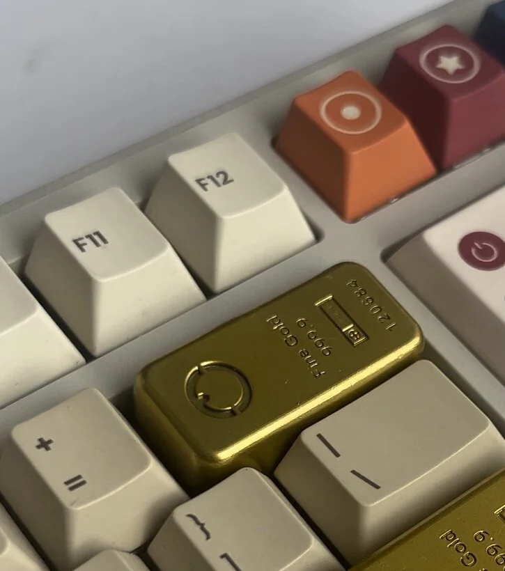 Close-up of a premium handcrafted Delta Force pure gold bar artisan keycap, meticulously crafted from resin with striking tactical accents.
