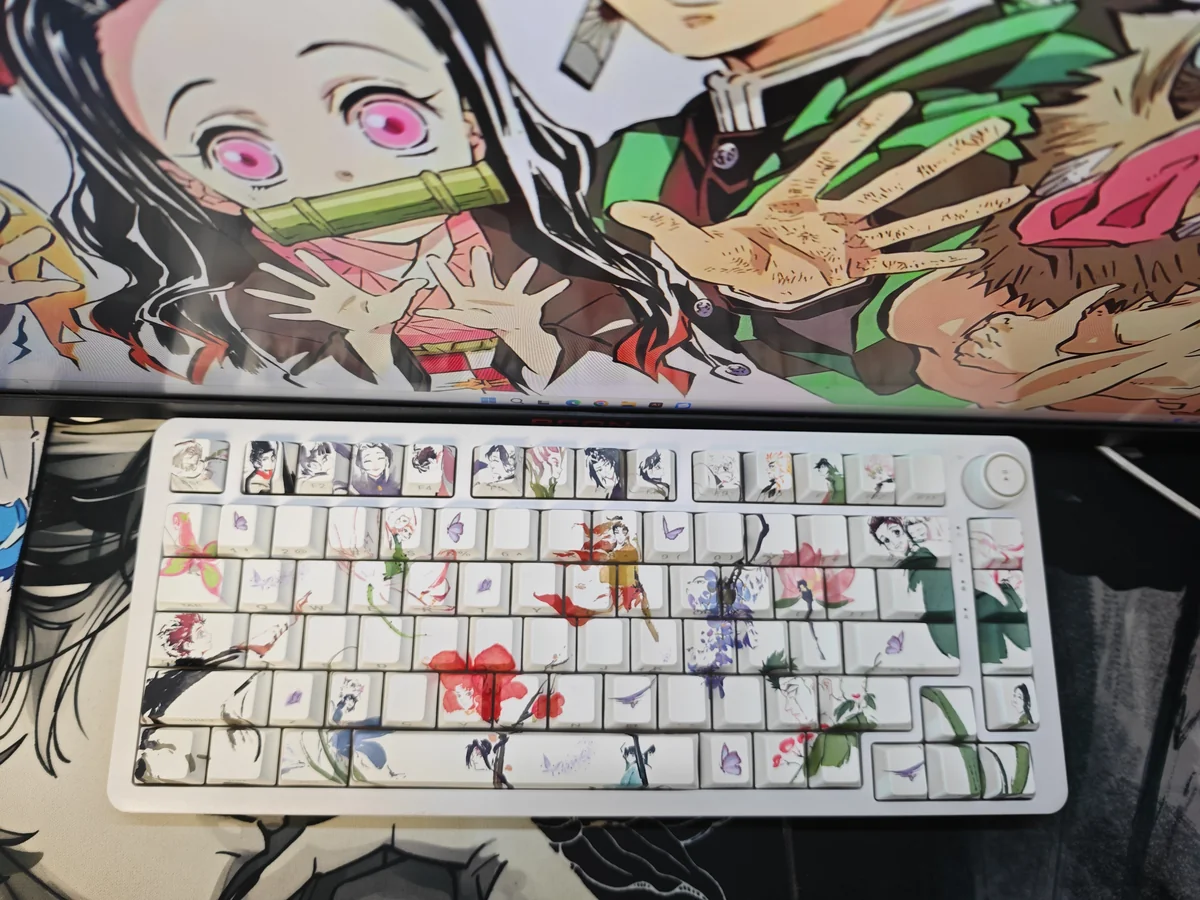 Close-up of artistic Demon Slayer PBT keycaps set, featuring vibrant side-printed anime characters and iconic motifs, perfectly designed for RGB backlight design.