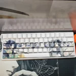Angled view of translucent Demon Slayer Giyu & Shinobu keycaps set, highlighting the exclusive side-engraved character art and elegant glow.