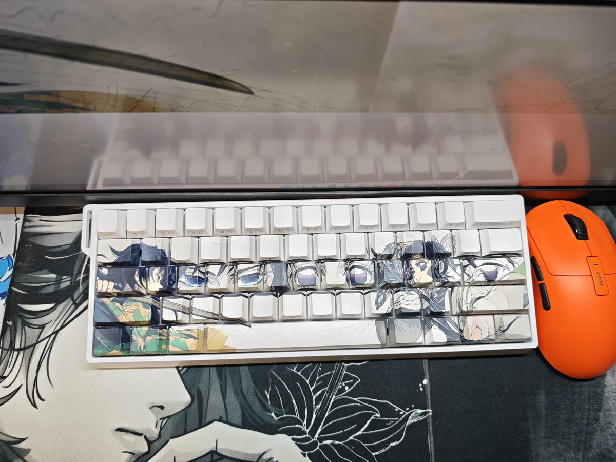 Angled view of translucent Demon Slayer Giyu & Shinobu keycaps set, highlighting the exclusive side-engraved character art and elegant glow.