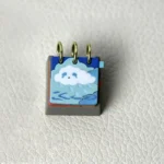 Close-up gallery of a handcrafted Resin Calendar Keycap, revealing intricate daily mood and weather designs from different angles. Unique artistic design.