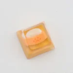 Close-up of the joyful handcrafted resin dog bowl keycap, showcasing its vibrant colors and intricate miniature details from multiple charming angles.