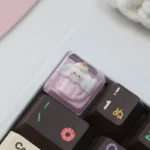 Adorable handcrafted resin artisan keycap featuring a whimsical dog waffle design and a sweet strawberry accent.