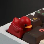 Vibrant red duck keycap, handcrafted from resin, offers delightful tactile stress relief. This adorable little red duck adds playful charm to your keyboard.