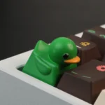 Adorable little green duck resin keycap, designed for tactile stress relief and adding playful charm to any keyboard.