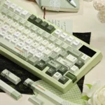 Artistic detail of Early Spring Green Keycaps, a premium PBT Dye-Sub set featuring gentle green gradients and subtle floral patterns.