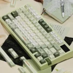 Early Spring Green Keycaps set, angled view, revealing premium PBT dye-sub quality, soft green hues, and artistic floral motifs for a refreshing sprig.