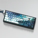A gallery of elegant Ancient Chinese PBT side-lit keycaps, showcasing various angles with serene ink wash designs and clean side-engraved legends.