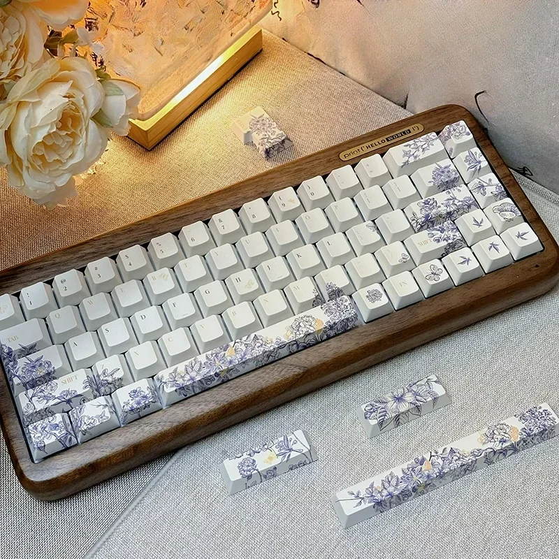 Close-up of artisan embroidered PBT keycaps set for Alice layout, showcasing intricate textile-inspired patterns and vibrant handcrafted details.