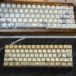 Artisan embroidered PBT keycaps set, showcasing intricate, handcrafted textile patterns with vibrant color accents and unique artistic design.