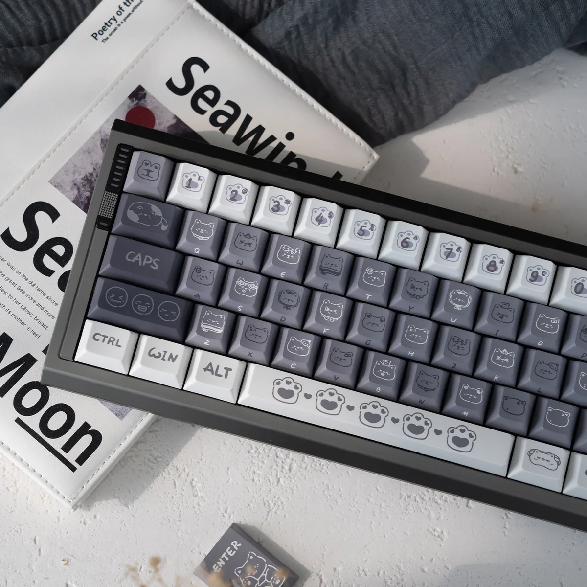 Unique Emo Kitten PBT keycap set from a dynamic angle, highlighting soft, durable finish and whimsical, expressive cat characters.