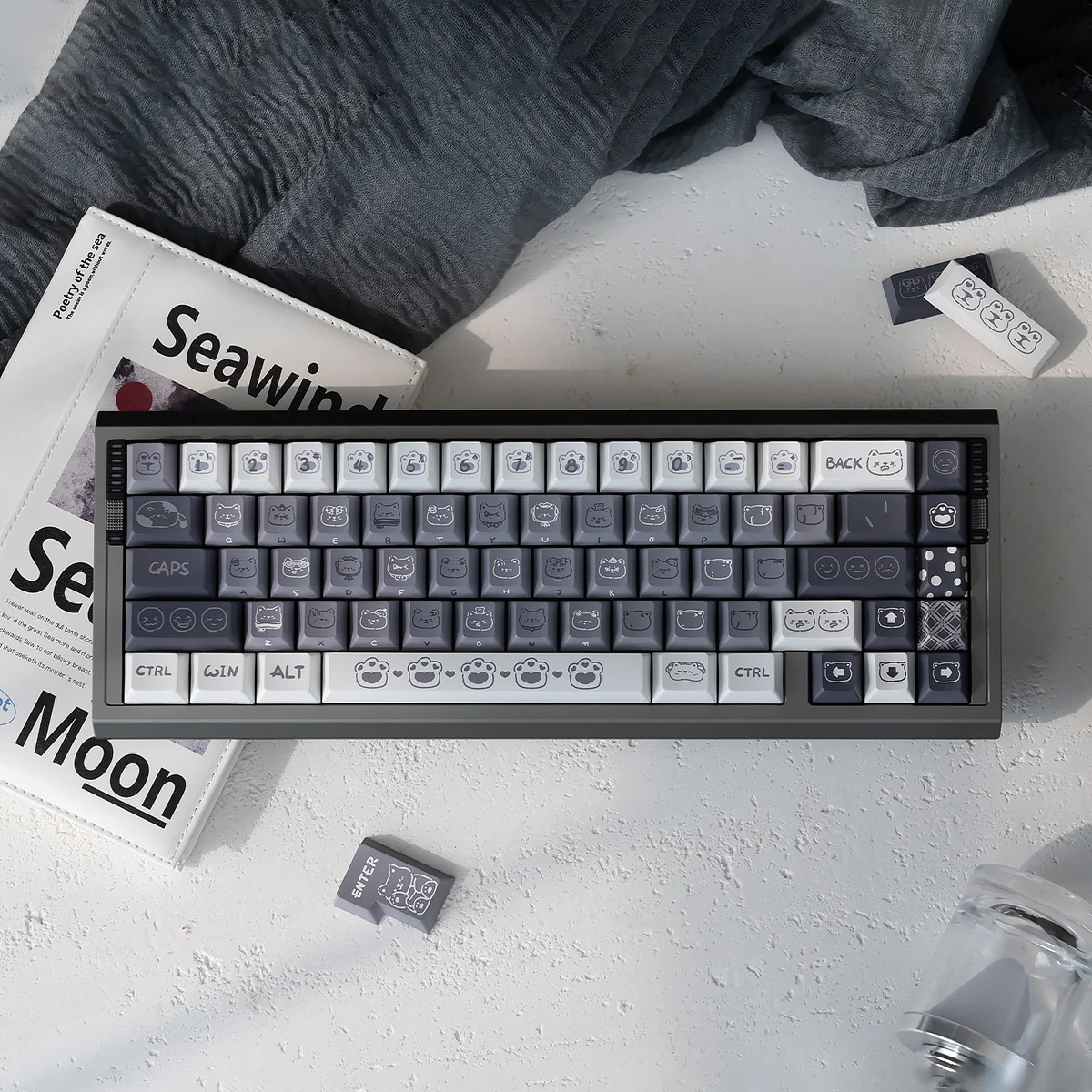 Showcasing the unique Emo Kitten PBT Keycap Set with whimsical, expressive cat characters. These durable PBT keycaps add playful feline charm to your keyboard.