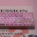 Encountered Folded Shadow Cherry Keycap Set: durable PBT keycaps, angled view, showing sharp geometric designs and abstract reflections, modern architecture.