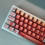 Exclusive Asuka & EVA Unit-02 Evangelion keycap set, vibrant red and orange metallic finish, displayed from multiple artistic angles. Highlights icon design.
