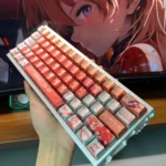 Exclusive Asuka & EVA Unit-02 Evangelion Keycap Set. Vibrant red and orange, striking metallic finish, shown from multiple artistic angles.