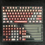 Exclusive Asuka & EVA Unit-02 Evangelion keycap set gallery, showcasing vibrant red, orange, and metallic Unit-02 aesthetic from diverse artistic angle.