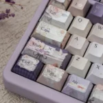 Dreamy Pearlescent Floral PBT Dye-Sub Keycap Set, showcasing delicate floral patterns and soft pearlescent sheen from various artistic angles.