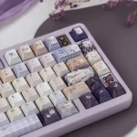 Artistic shot: Dreamy Pearlescent Floral PBT Keycaps Set, revealing delicate patterns and soft pearlescent sheen from a unique angle.