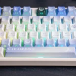 An exclusive Genshin Impact Columbina PBT keycap set, showcasing ethereal character art and celestial moon designs from a captivating angle.