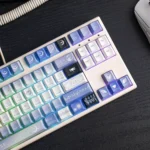 Exclusive Genshin Impact Columbina PBT keycaps set, artistically showcasing ethereal character art and celestial moon aesthetics from a detailed angle.