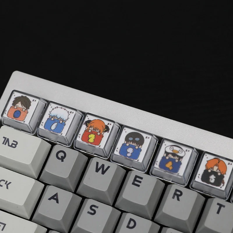 An artistic side view of the whimsical Gintama sleeping artisan resin keycaps set, revealing the intricate details and vibrant, glossy finish of these unique design.